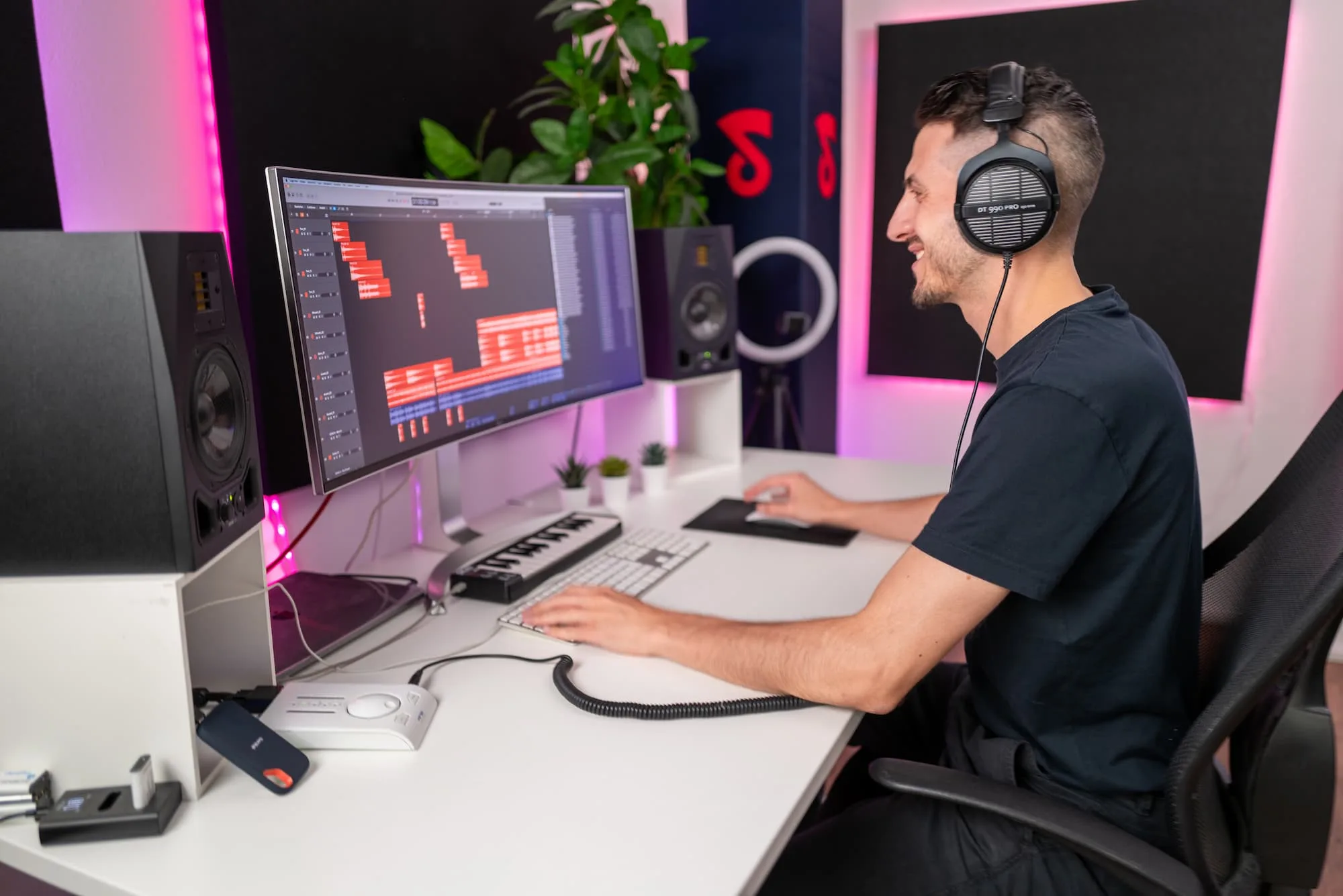 Mastering engineer working at a studio desk with headphones on